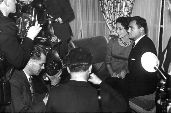 Elizabeth Taylor with husband Mike Todd facing the cameras in London in April 1957 circa