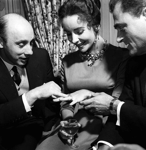 Elizabeth Taylor with Husband Mike Todd showing off diamond ring to Donald Zec