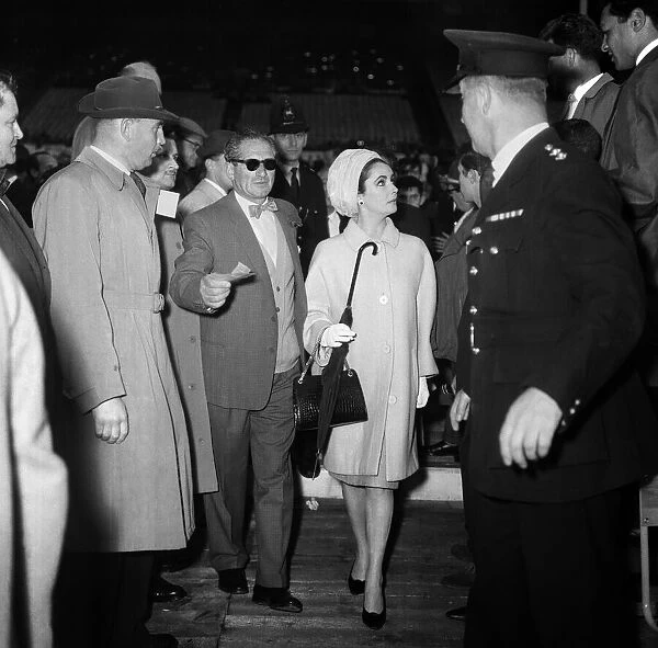 Elizabeth Taylor walking to her seat at Wembley Stadium for the Cassius Clay