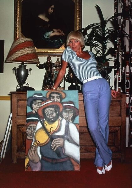 Elke Sommer, actress inside a house standing next to a painting sex