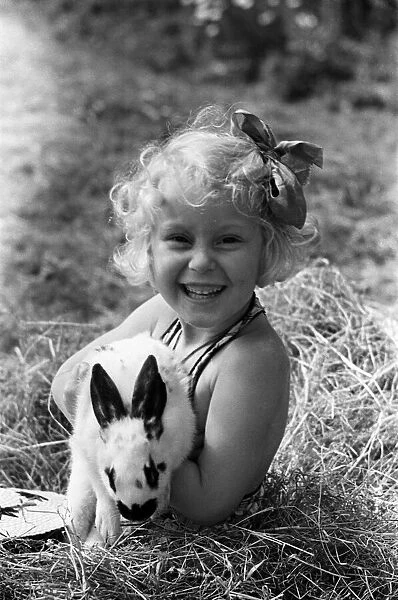 Ella Edwards holding a rabbit. August 1941