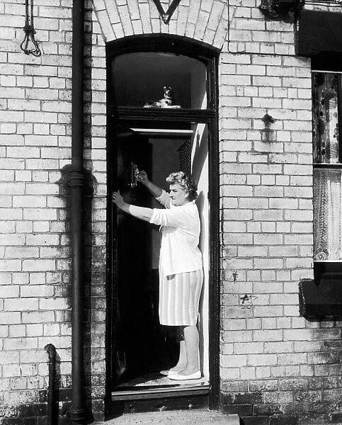 Elsie Starkey, mother of Ringo Starr, July 1964. Pictured polishing door knocker at No