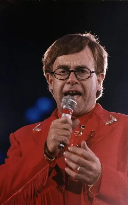 Framed Print : Elton John circa 1992 Wearing Red Suit as he holds microphone during a Freddie Framed Print : Elton John circa 1992 Wearing Red Suit as he holds microphone during a Freddie