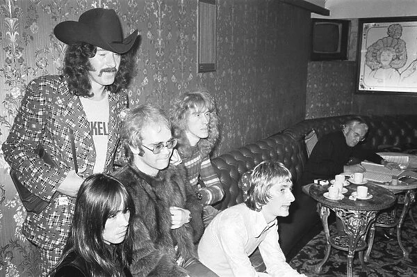 Elton John and his group pose for pictures in the Palladium bar during rehearsals for
