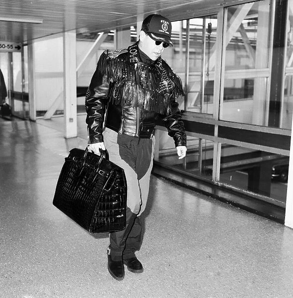 Elton John at Heathrow Airport, London. 25th September 1987