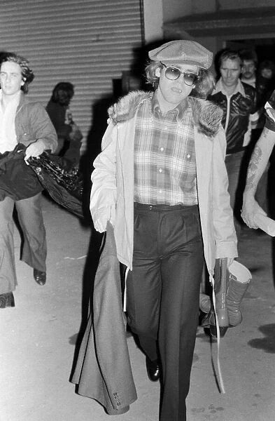 Elton John leaving the Empire Pool Wembley by the back door after he announced his