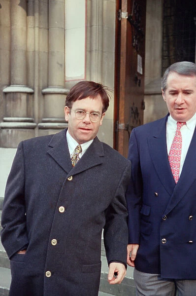 Elton John and his manager John Reid at the High Court for a Libel Case against