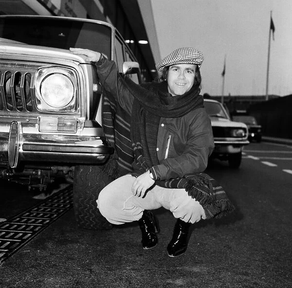 Elton John pictured next to an American Jeep at London Airport. February 1979
