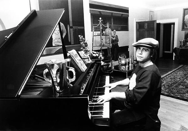 Elton John pictured seated at a piano. December 1978. Published in