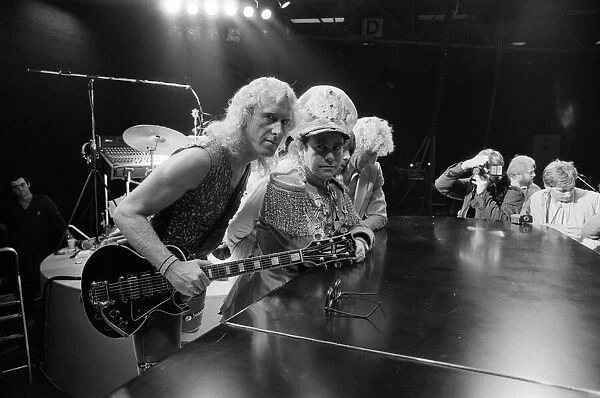 Elton John pictured on stage with other musicians, during preperations for his Jump Up