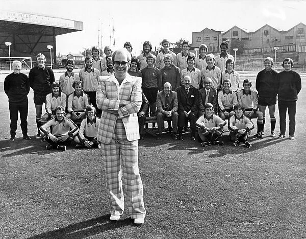 Elton John poses with his team of players and staff of Watford Football club