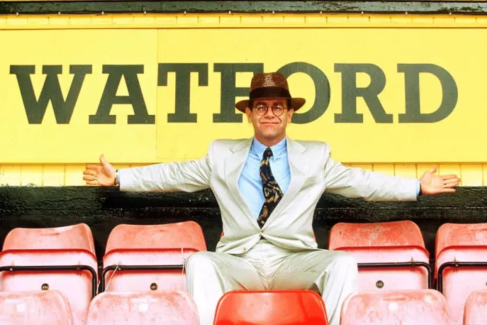 Framed Print : Elton John on rejoining Watford football club as director sitting in front of sign white Framed Print : Elton John on rejoining Watford football club as director sitting in front of sign white