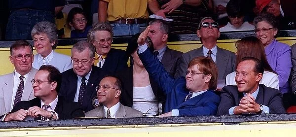 Elton John second right singer and Watford FC Chairman waves to the crowd after receiving