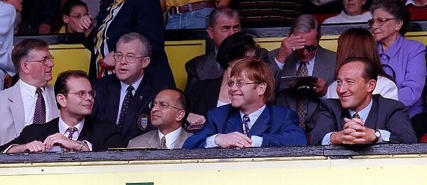 Elton John second right singer and Watford FC Chairman waves to the crowd after receiving
