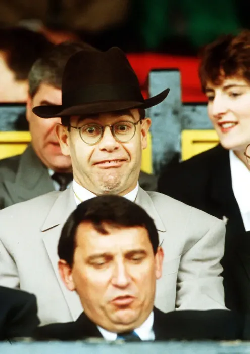 Framed Print : Elton John Singer & Chairman of Watford FC pulls a funny face at Manager Graham Taylor