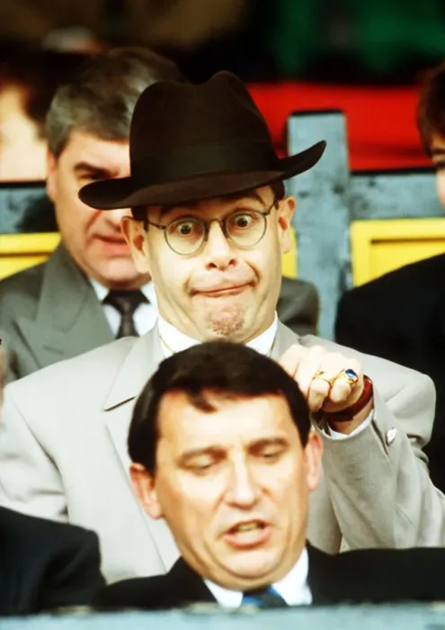Framed Print : Elton John Singer & Chairman of Watford FC pulls a funny face at Manager Graham Taylor