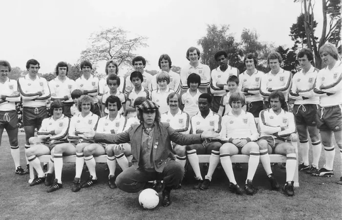 Framed Print : Elton John superstar and members of the England football team pose with schoolchildren in