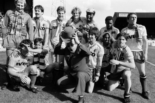 Elton John and the Watford side pose for the photographers after their match against