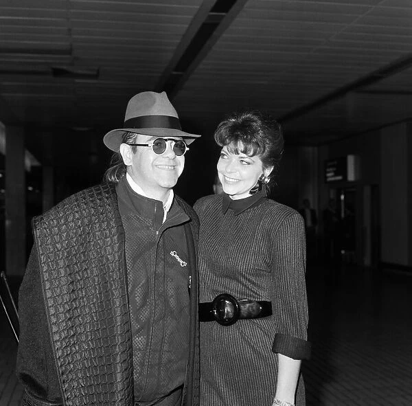 Elton John with his wife Renate arriving from Los Angeles at London Airport