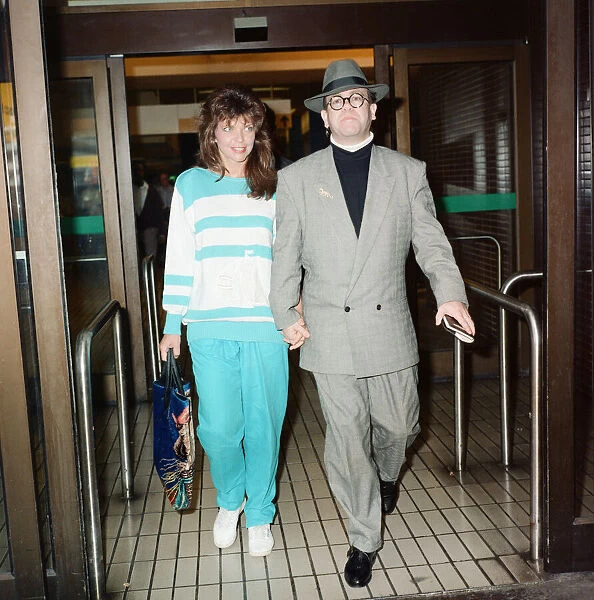 Elton John and his wife Renate at London Airport. 29th July 1988