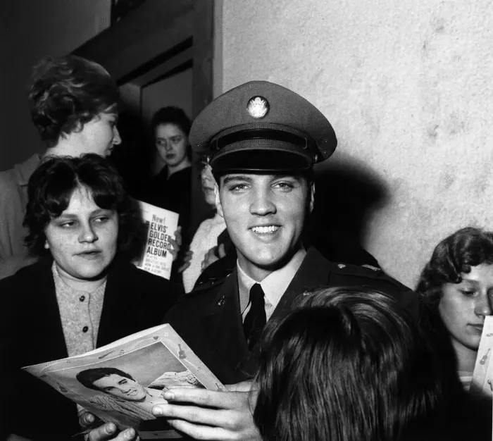 Framed Print : Elvis Presley signs autographs at press conference March 1960 for fans in Germany