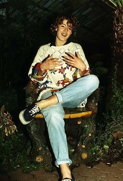 Emily Lloyd Actress sitting cross legged in wood carved chair A©Mirrorpix