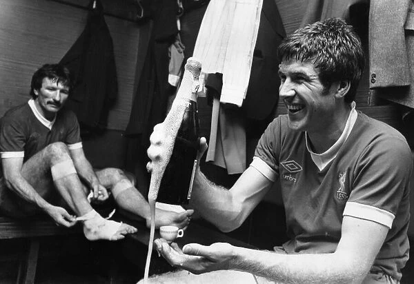 Emlyn Hughes celebrates the League Championship title with a bottle of champagne in