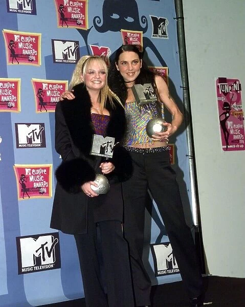 Emma Bunton and Mel C of all girl pop group The Spice Girls holding their awards at