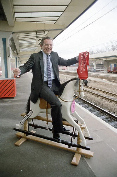 Employment Secretary, Norman Fowler, on a rocking horse
