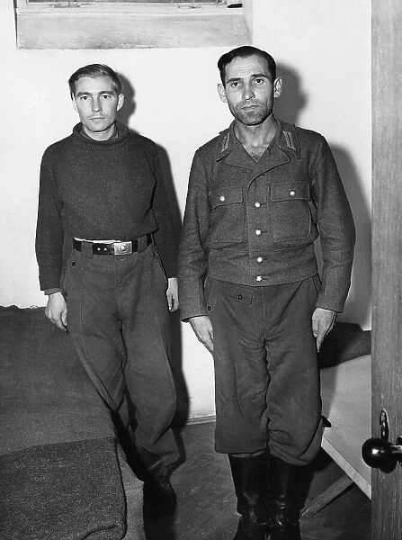 Engelbert Nadermayer (right) who was formerly in charge of the notorious crematorium at Dachau, shown in his cell alongside a former SS trooper who is also on the list of war criminals to be tried. 20th September 1945