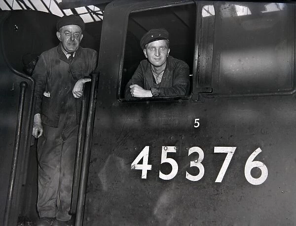 Engine driver and fireman on the footplate of thier locomotive at Charing Cross station