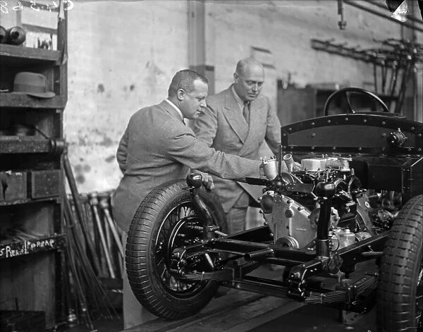 Engine mounted on the chassis of a car on the production line is inspected at the Triumph