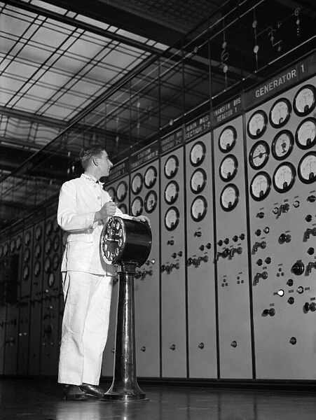 Engineer watching a bank of dials in the Control Hall of Battersea Power Station