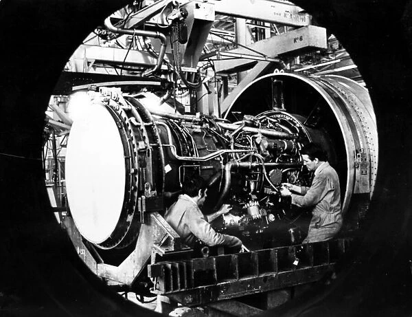 Engineers work on a Pratt and Whitney jet engine from Boeing 747 at Nantgarw