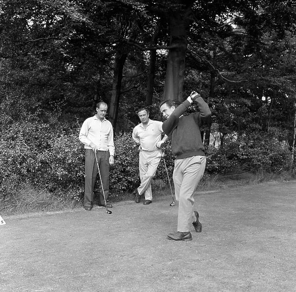 England cricketer Bobby Simpson enjoys a game of golf at Morton Golf Club watched by