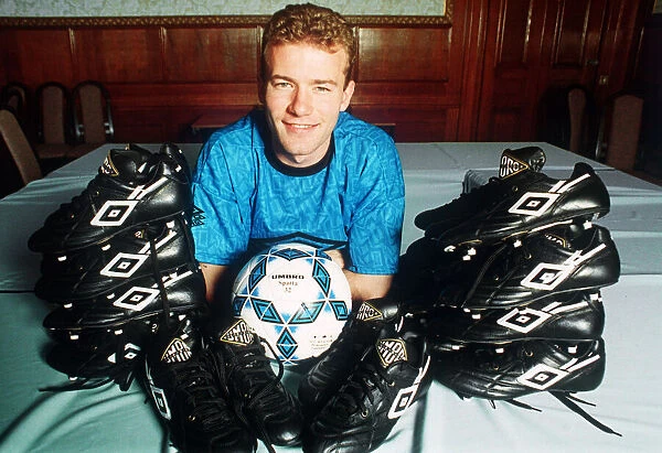 England footballer Alan Shearer footballer posing surrounded by football boots, 1992
