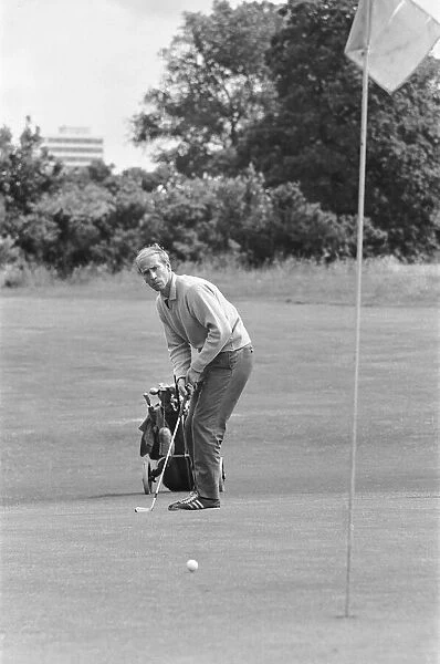 England footballer Bobby Charlton enjoys a round of golf during an England team get