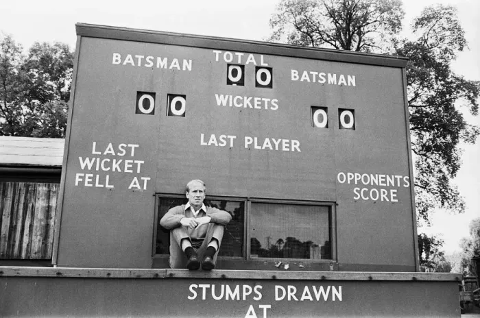 Framed Print : England footballer Bobby Charlton sidts in front of a cricket scoreboard at the team Framed Print : England footballer Bobby Charlton sidts in front of a cricket scoreboard at the team