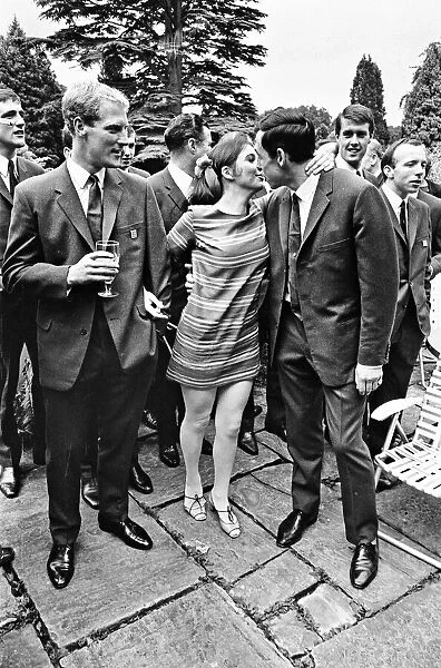 England footballer Gordon Banks gives a kiss to actress Vivienne Ventura watched by Ron