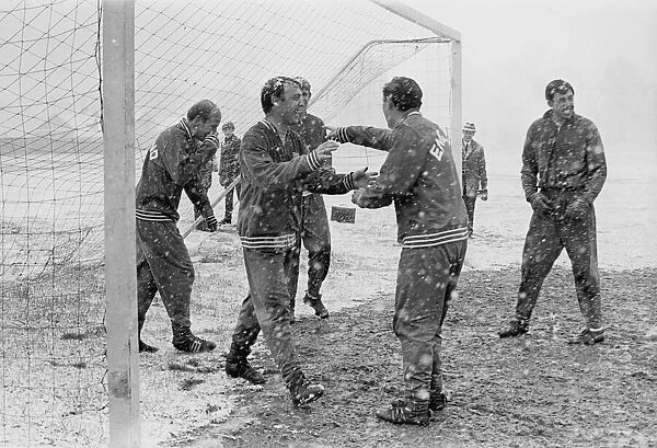 England footballer Jimmy Greaves laughs as he walks out the goal during a snow covered