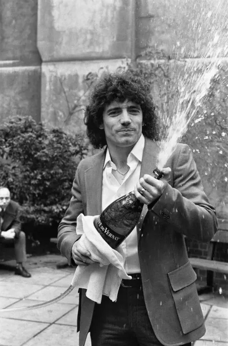 Framed Print : England footballer Kevin Keegan poses for photographers holding a large champagne bottle Framed Print : England footballer Kevin Keegan poses for photographers holding a large champagne bottle