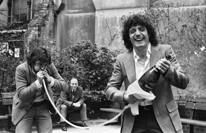 Framed Print : England footballer Kevin Keegan poses for photographers holding a large champagne bottle