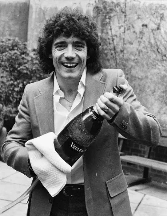 Framed Print : England footballer Kevin Keegan poses for photographers holding a large champagne bottle