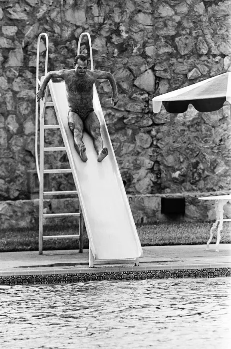Framed Print : England footballer Ray Wilkins slides into the swimming pool at the Cima Club in