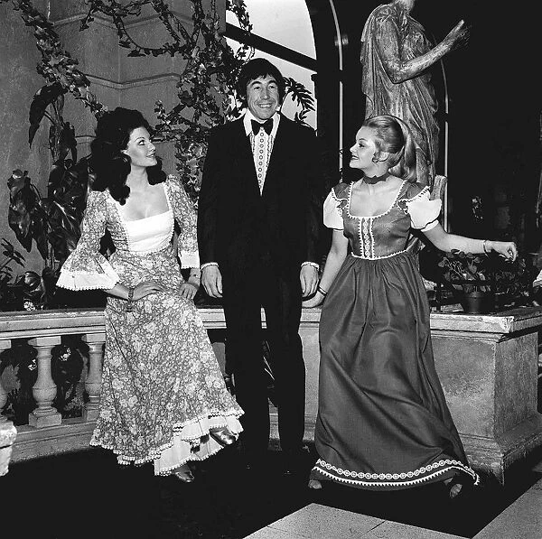 England goalkeeper Gordon Banks wearing a tuxedo and bow tie as he stands with two girls