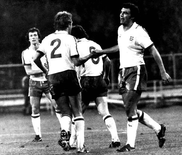 England goalscorer Trevor Brooking is congratulated by teammates after scoring in