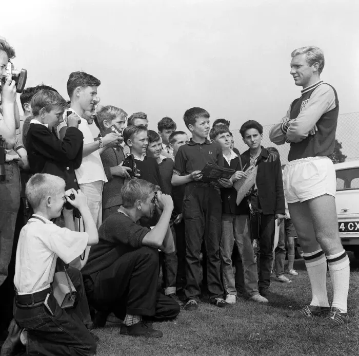 Framed Print : England player Bobby Moore August 1962 poses for young fans during West ham United Framed Print : England player Bobby Moore August 1962 poses for young fans during West ham United