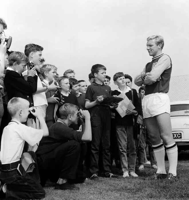 Framed Print : England player Bobby Moore poses for young fans during West Ham United Training