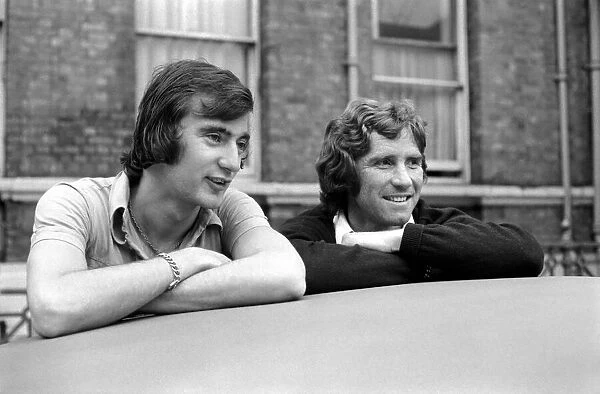 England Players: Alan Hudson and Alan Ball leaning on a car top watching the World go by