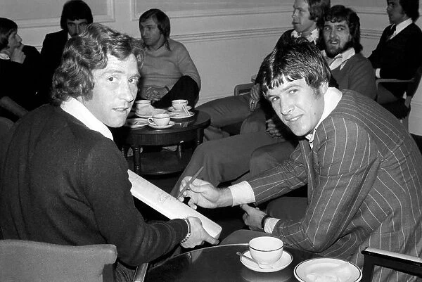 England Players: Emlyn Hughes and Alan Ball with a cricket bat that was autographed by